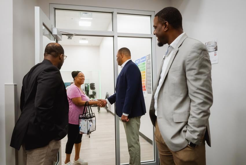 FORT WORTH, TEXAS — AUGUST 22, 2025: U.S. Rep. Marc Veasey, D-Fort Worth, second from right, shakes hands with  constituent Cee Ellis during a tour of the Eastside YMCA in Fort Worth, Texas, on Aug. 22, 2025. Rep. Veasey helped secure federal funding to revitalize the Eastside YMCA. His congressional district will be significantly altered under newly approved redistricting map passed by the Texas Legislature, which would remove Fort Worth, his hometown and political base, and shift the district entirely into Dallas County. CREDIT: Desiree Rios for The Texas Tribune