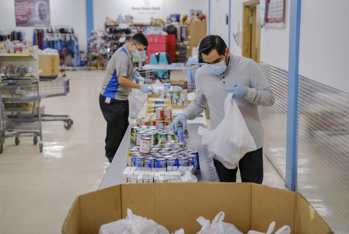 Staff members at the St. Andrews food pantry run by the Catholic Charities in San Antonio on Feb. 25, 2021.