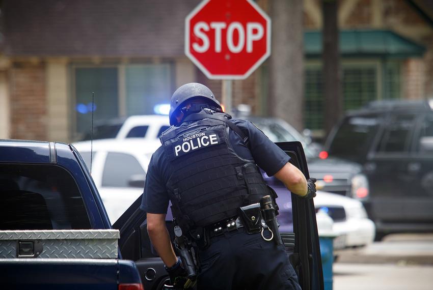 A Houston police officer on the scene in a west Houston neighborhood where a gunman with an assault rifle shot one man and injured six before being killed by a SWAT officer on May 29, 2016. 