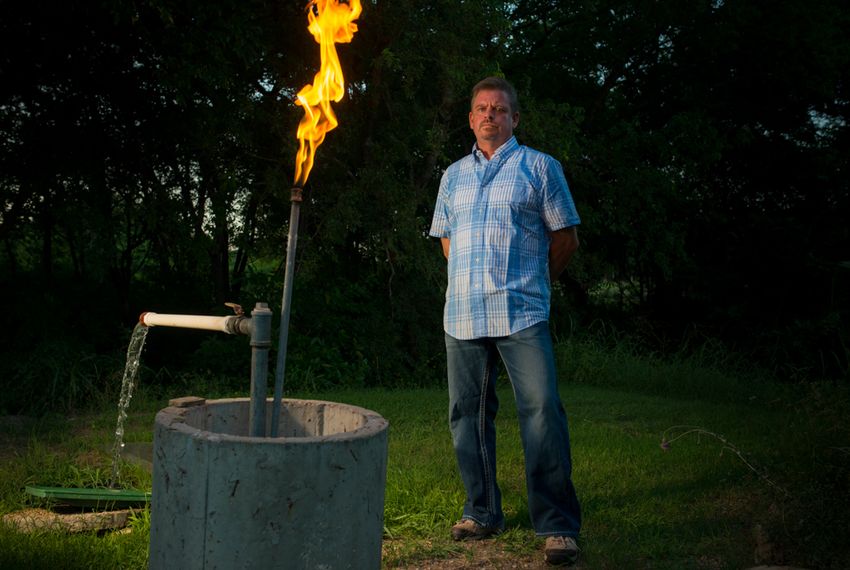 Steve Lipsky shows the methane contamination of his well by igniting the gas with a lighter outside his family's home in Parker County near Weatherford, Texas on June 17, 2014.