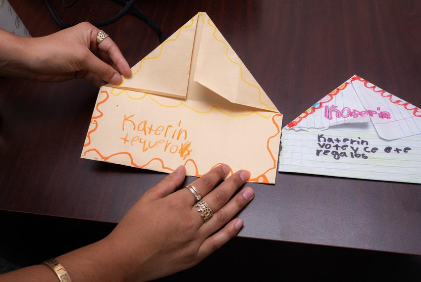 Katerin M.S., 24, works as a full-time case worker at Tejano Center Placing Agency, where she serves children who have experienced loss, neglect and abuse, and decorates her office with drawings the children make for her. She manages her schoolwork from the office while balancing her job on Sunday, Aug. 17, 2025, in Houston.