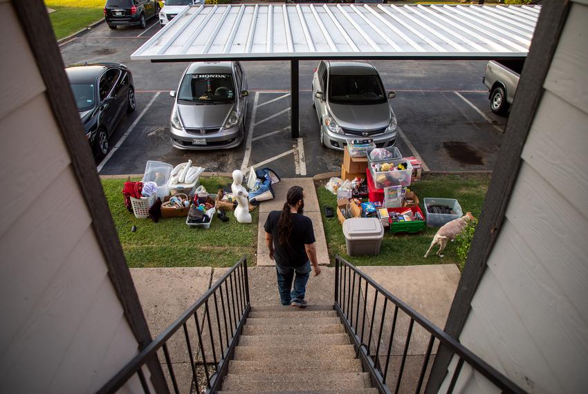 Jared Brown looks over his family’s belongings on the morning of their eviction from their Plano apartment.