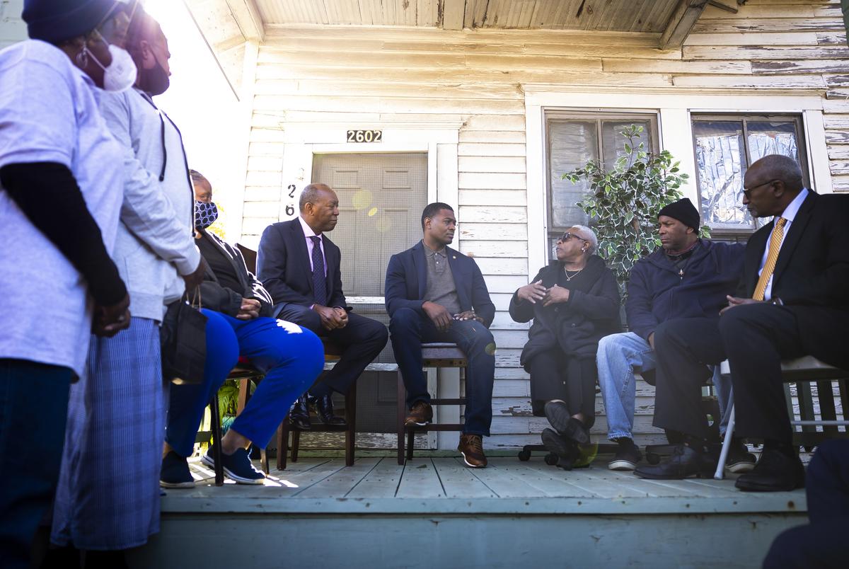 EPA Administrator Michael Regan listens to resident Doris Brown on Carol Thomas’s porch during a tour of Fifth Ward on Nov. 19, 2021.