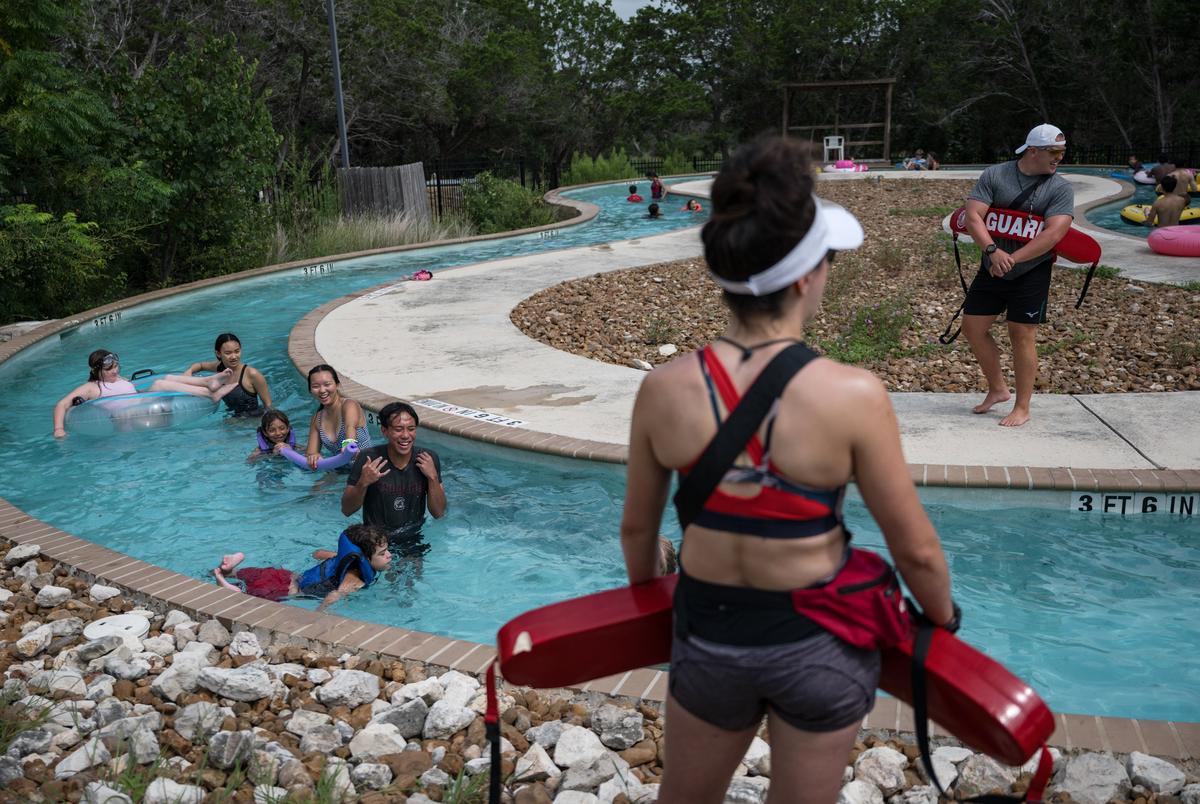 Lifeguards watch over campers and counselors as they float along the lazy river at Camp CAMP, a summer camp hosted by Children’s Association for Maximum Potential for people with disabilities, on Tuesday, July 22, 2025, in Center Point.