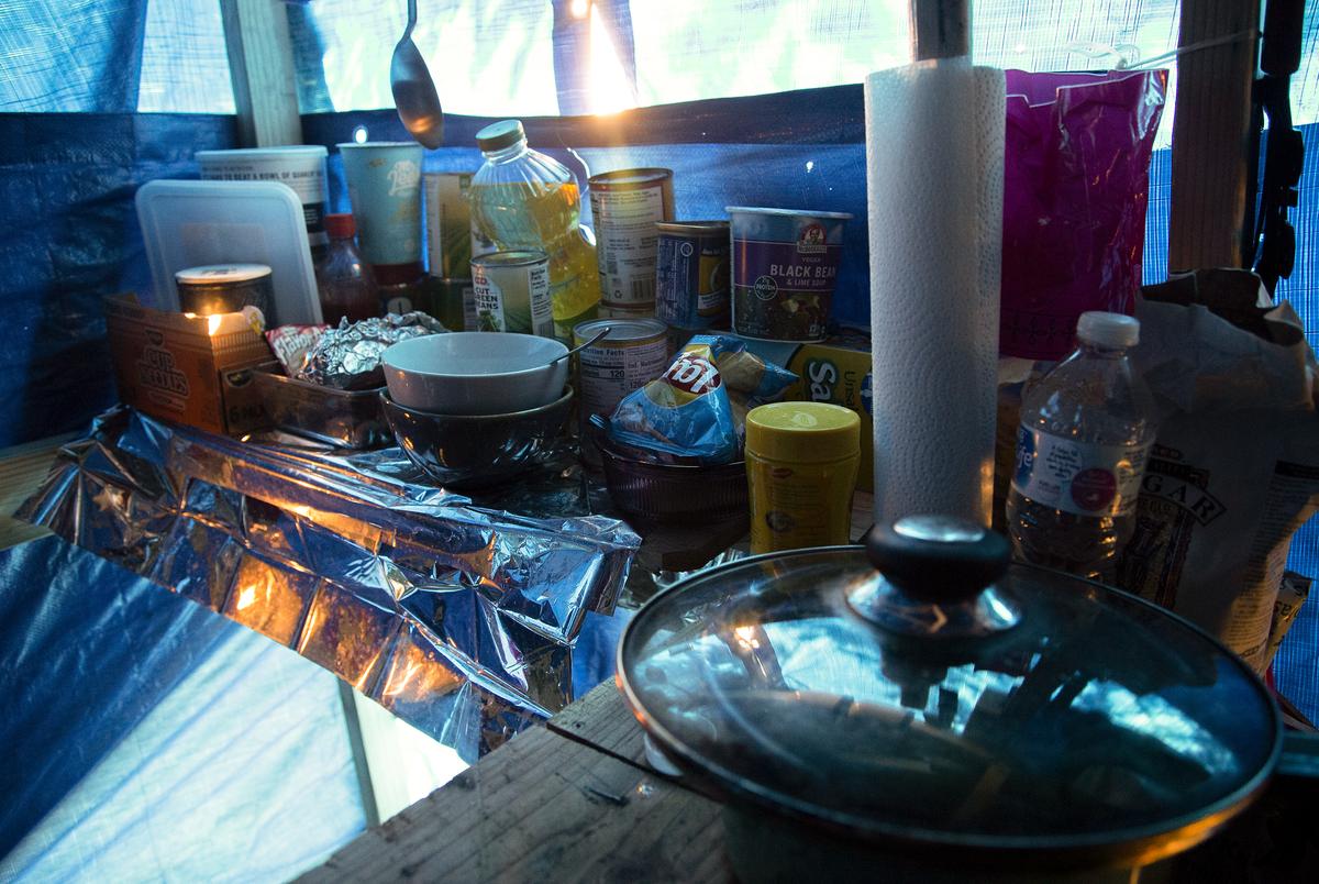The inside of a shelter in Austin, which includes a wood floor and latching gate. Jan 15, 2021.