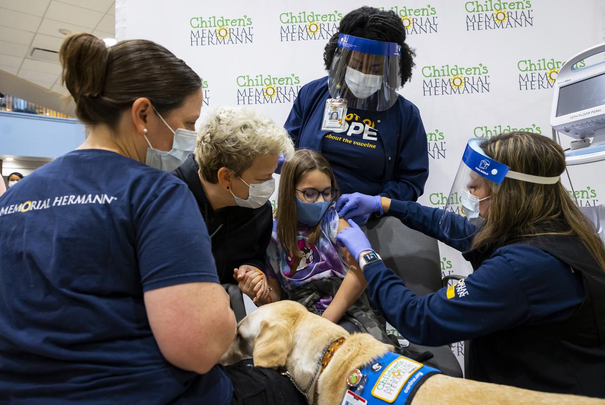 Nurses point out how they avoided a mosquito bite to ten-year-old Miranda Morales after she received her first dose of the Pfizer pediatric COVID-19 vaccine at Memorial Hermann-Texas Medical Center in Houston, TX, on Wednesday, Nov. 3, 2021.