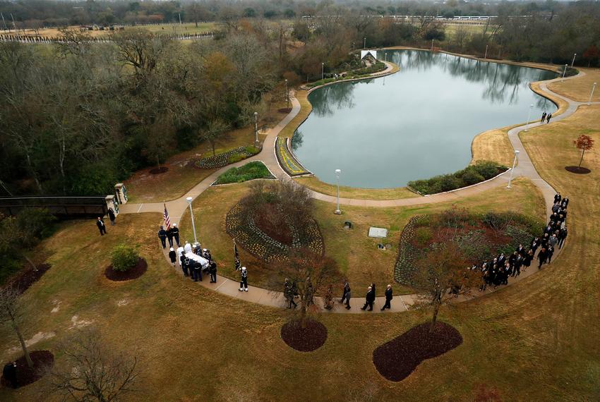 The flag-draped casket of former President George H.W. Bush was carried by a joint services military honor guard followed by family members at the George H.W. Bush Presidential Library and Museum in College Station.