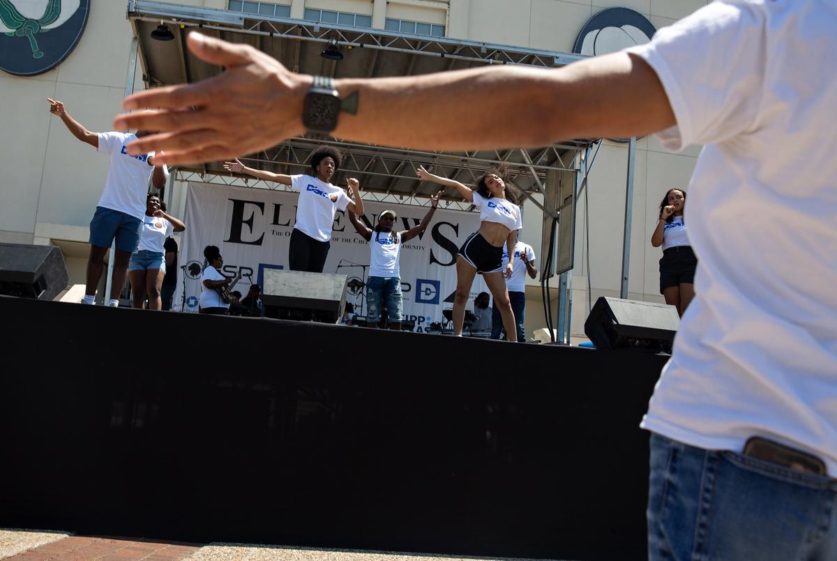 Dallas Summer Musicals director of education and community partnerships Devon Miller leads the group in a run through performance during the Juneteenth Festival at Fair Park in Dallas on June 19, 2021.
