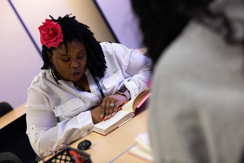 Schnique Dory reads from “The Handmaid's Tale” with her students on Wednesday, Nov. 6, 2024 in Fort Worth, Texas. Dory includes interactive elements in class including introduction responses, reading, written responses to questions and exit questions, providing students with multiple learning avenues.