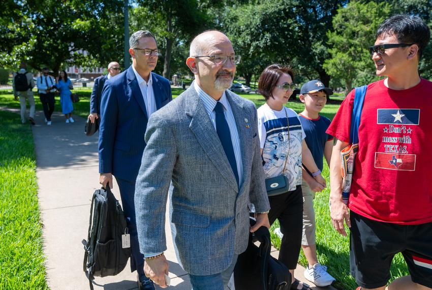 Texas Democrats Jon Rosenthal, D-Houston and Rafael Anchia, D-Dallas, l,  get off a charter bus from the Austin airport outside the State Archives building on the east side of the Texas Capitol upon their return to Austin following a two-week quorum break.  Man at right is unidentified.