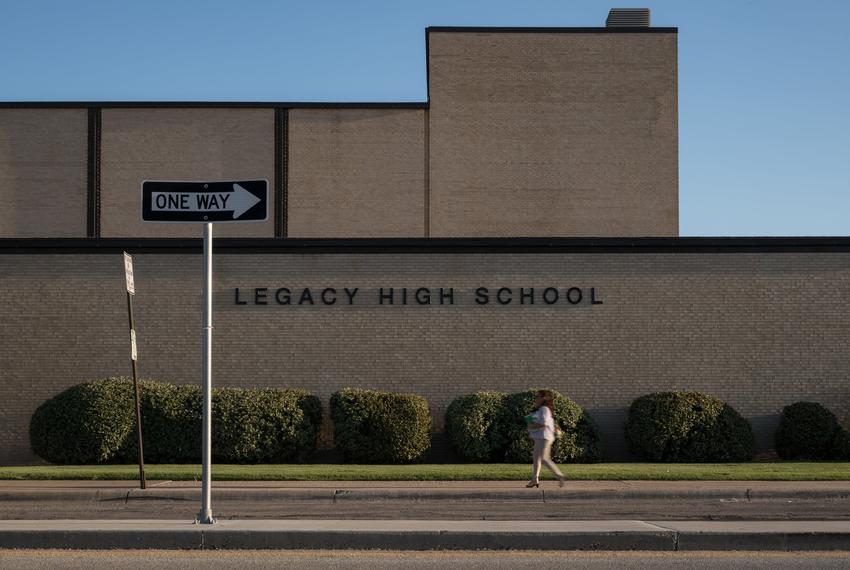 A Midland ISD employee walks past the front of Legacy High School on Thursday, Aug. 7, 2025, in Midland.