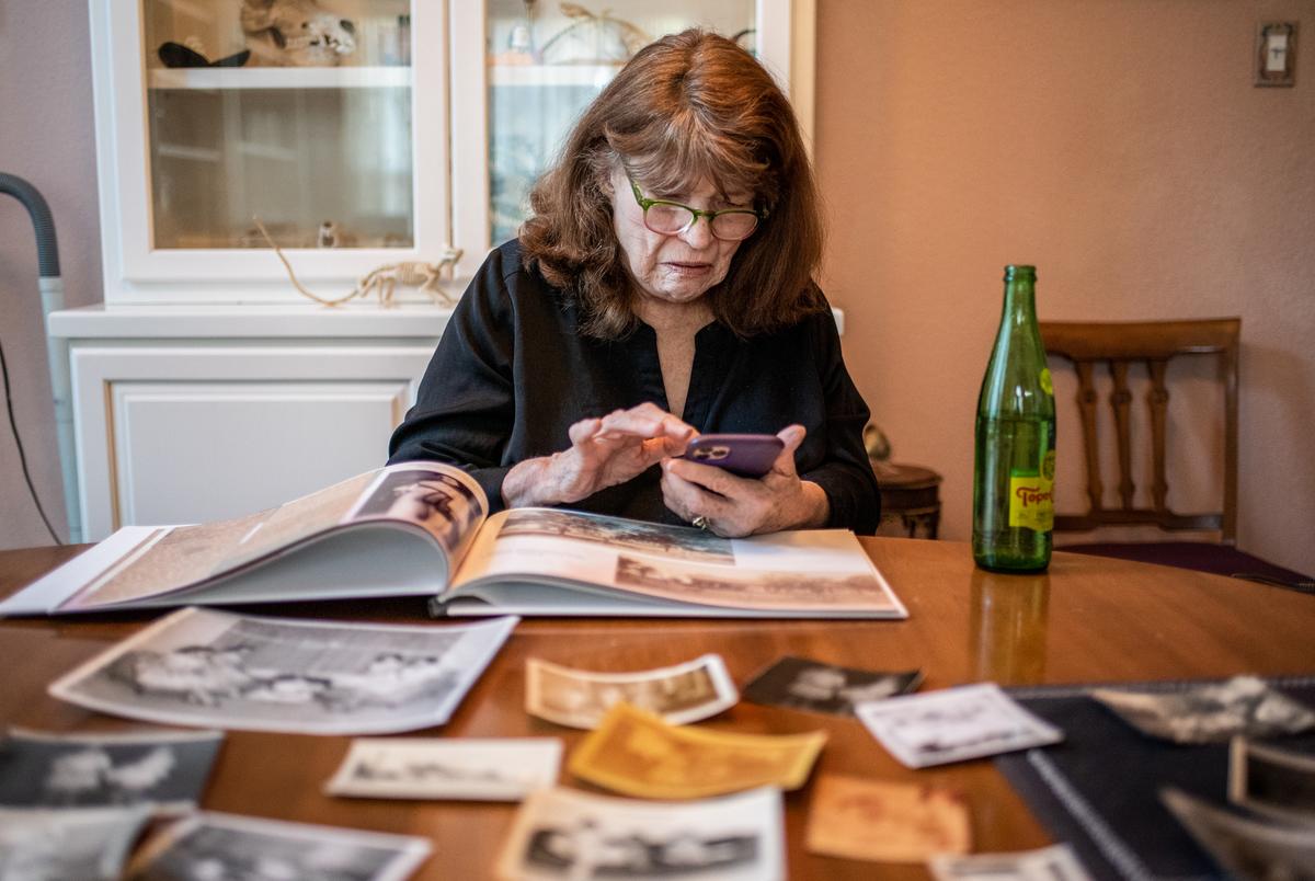 Jo Carol Pierce looks looks through family photos at her sister Beth’s home in Austin.