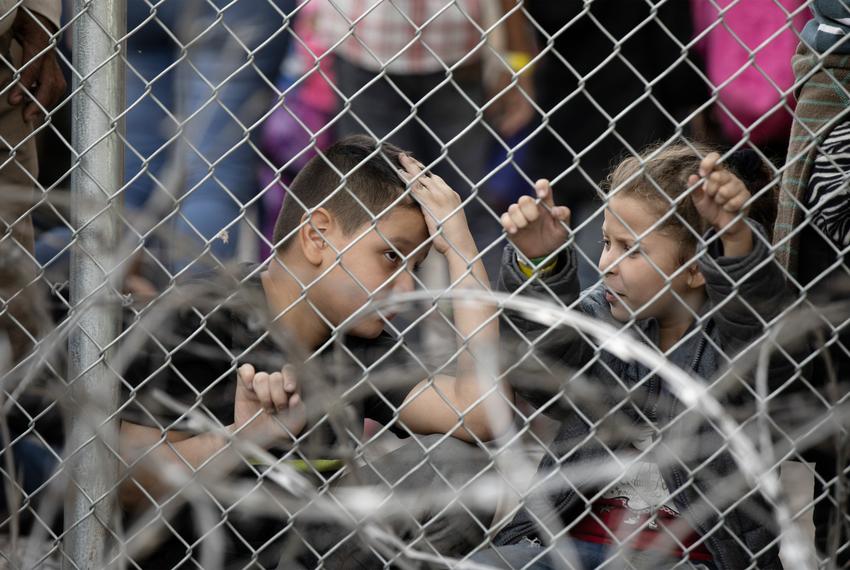 Two young children are seen inside a temporary migrant holding area setup by CBP under the Paso del Norte International port of entry between Ciudad Juárez and El Paso on March 27, 2019.