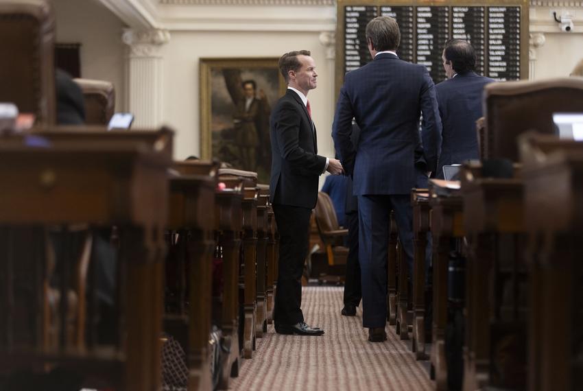 State Rep. Dade Phelan, R-Beaumont, speaks with other representatives on the House floor on May 19, 2025.
