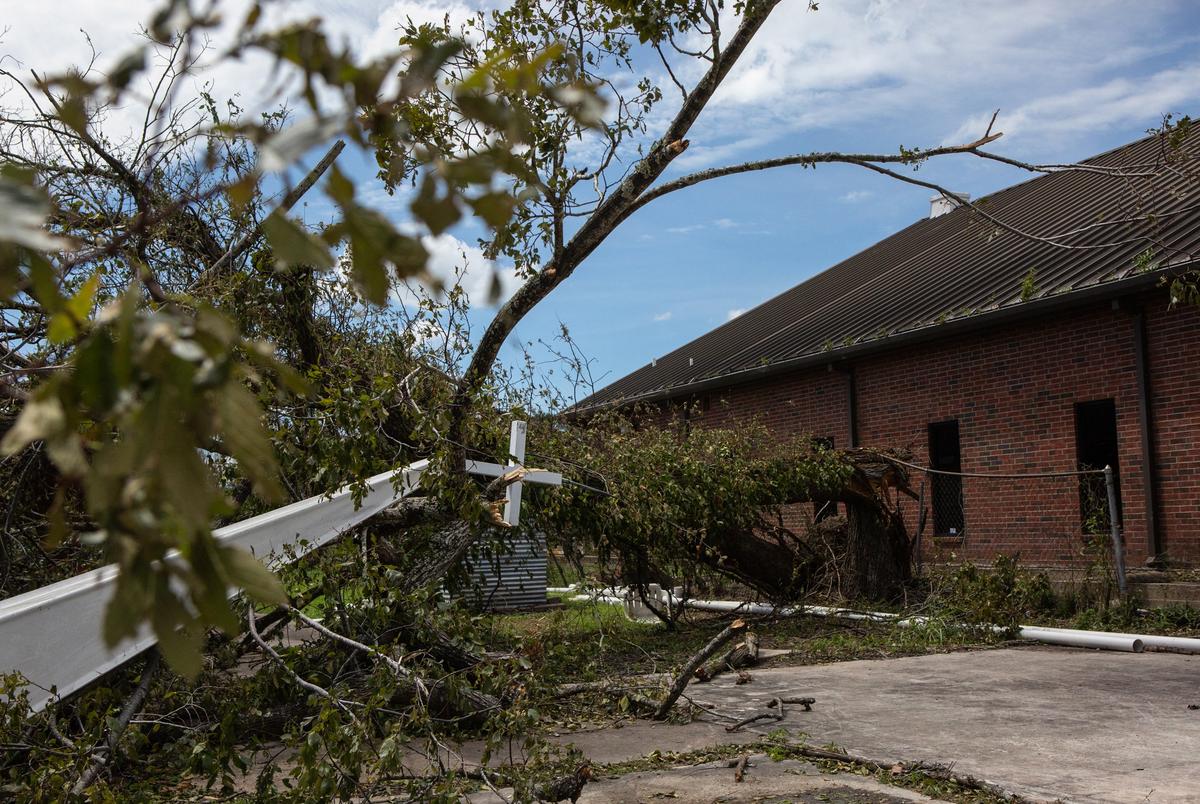 The Mount Calvary Baptist Churchís steeple lays entangled with tree debris on the ground after Hurricane Laura blew through Orange on Aug. 27, 2020.