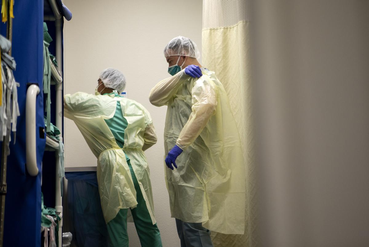 Nurses prepare to enter the COVID-19 unit at the Doctors Hospital at Renaissance Health System in Edinburg. June 30, 2020. Because of the risk of exposure to COVID-19, nurses are required to wear personal protective equipment.
