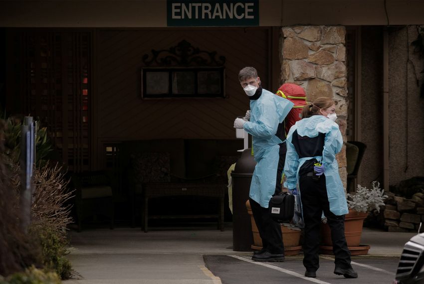 Medics prepare to transfer a patient on a stretcher to an ambulance at the Life Care Center of Kirkland, the long-term care facility linked to the two of three confirmed coronavirus cases in the state, in Kirkland, Washington on March 1, 2020.