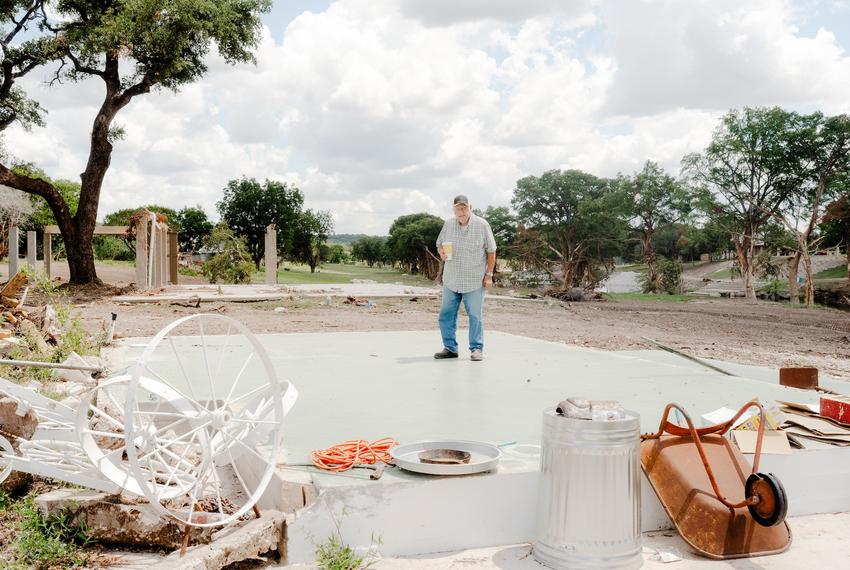 Wayne O’Bryant, an Ingram resident, stands on a concrete slab along the banks of the Guadalupe River where his cabin stood before the July 4 flood swept it away.