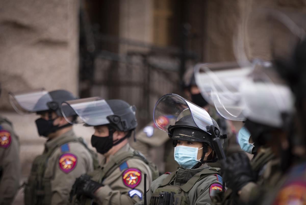 State troopers stand guard outside of the state Capitol's north entrance on the opening day of the Legislative Session on Jan. 12, 2021.