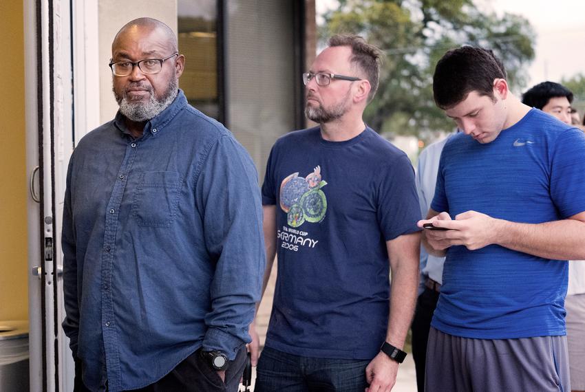 Lucious Henderson waits to vote on at the George Washington Carver Library in Austin. He said he is voting for Democrat Hillary Clinton because he believes she is the best choice for president. The 62-year-old construction inspector said the most important issue to him to this year is the economy.