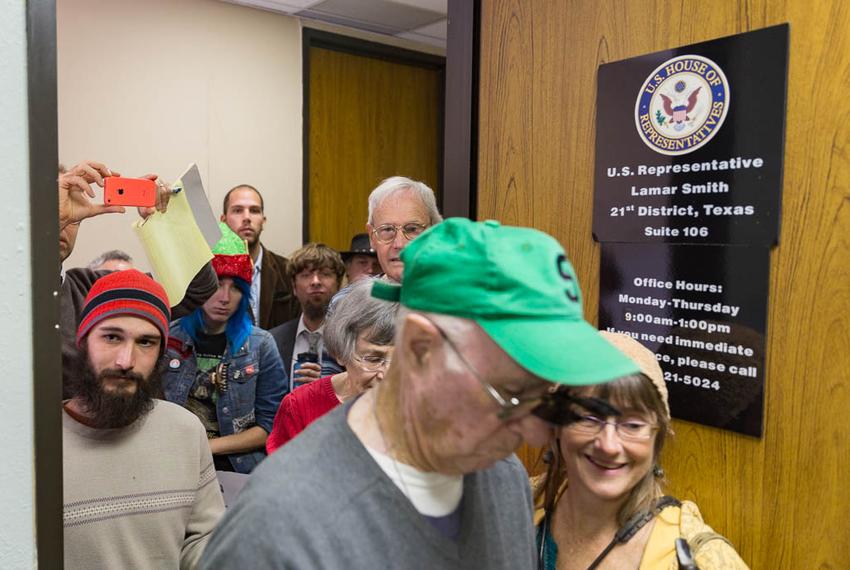 Climate change activists crowd Representative Lamar Smith's office to present him with the "Flat Earth Foundation of Texas" Award for "Semi Skeptic" of Distinction on Dec. 7th, 2015. Photo by: Shelby Knowles