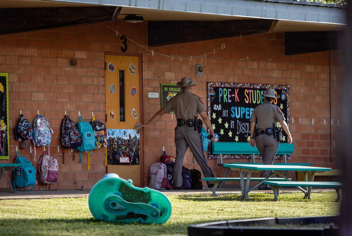 Two DPS officers test classroom doors and patrol the campus at Dalton Elementary School on the first day of school in Uvalde on Sept. 6, 2022.