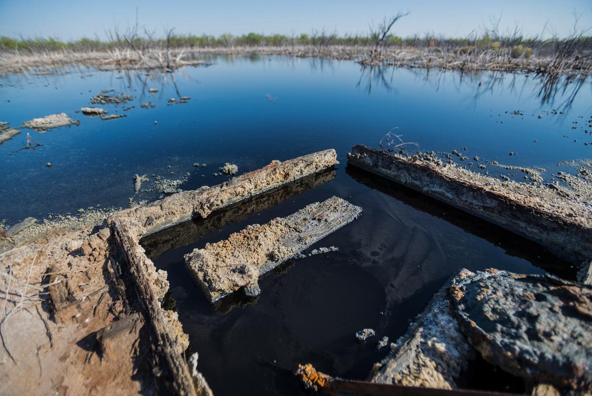 Brackish water flows from an unplugged abandoned well outside Imperial in Pecos County — one of several in the area likely drilled for oil but later tapped for water.