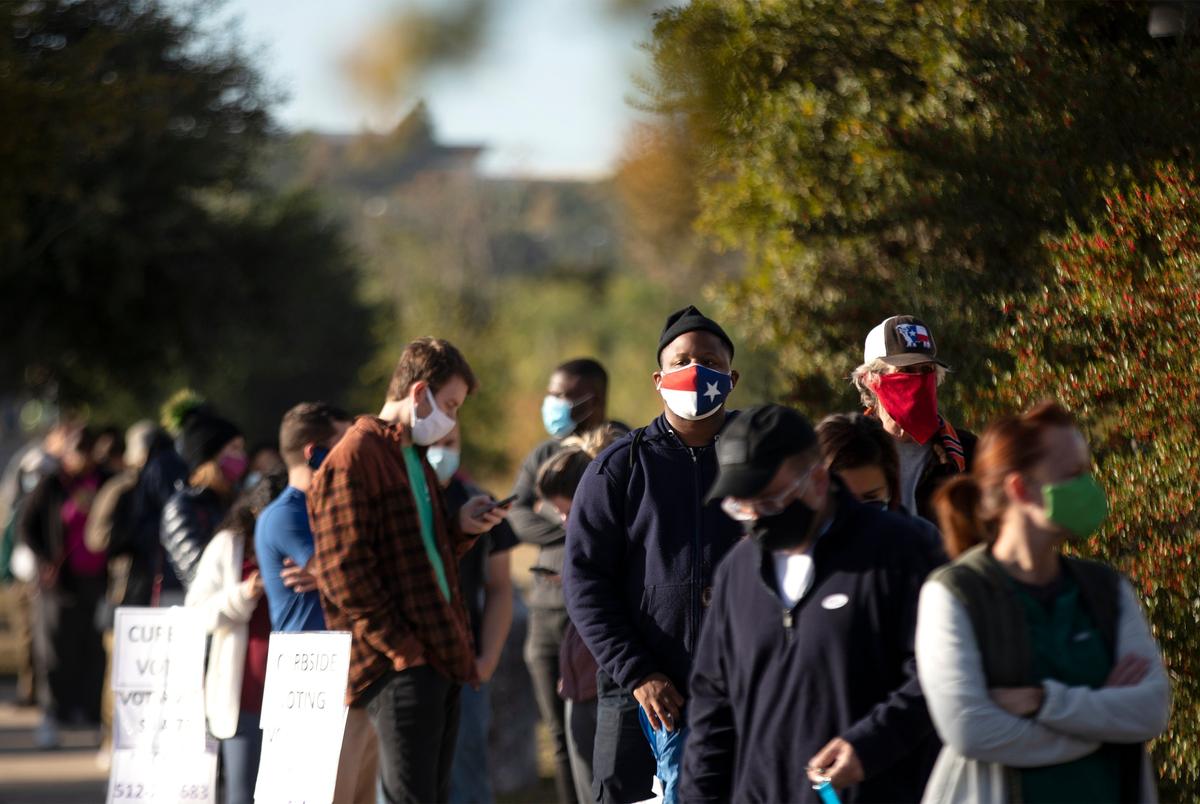 Voters wait in line to cast their ballots at Dan Ruiz Branch Library in Austin on Election Day. Nov. 3, 2020.