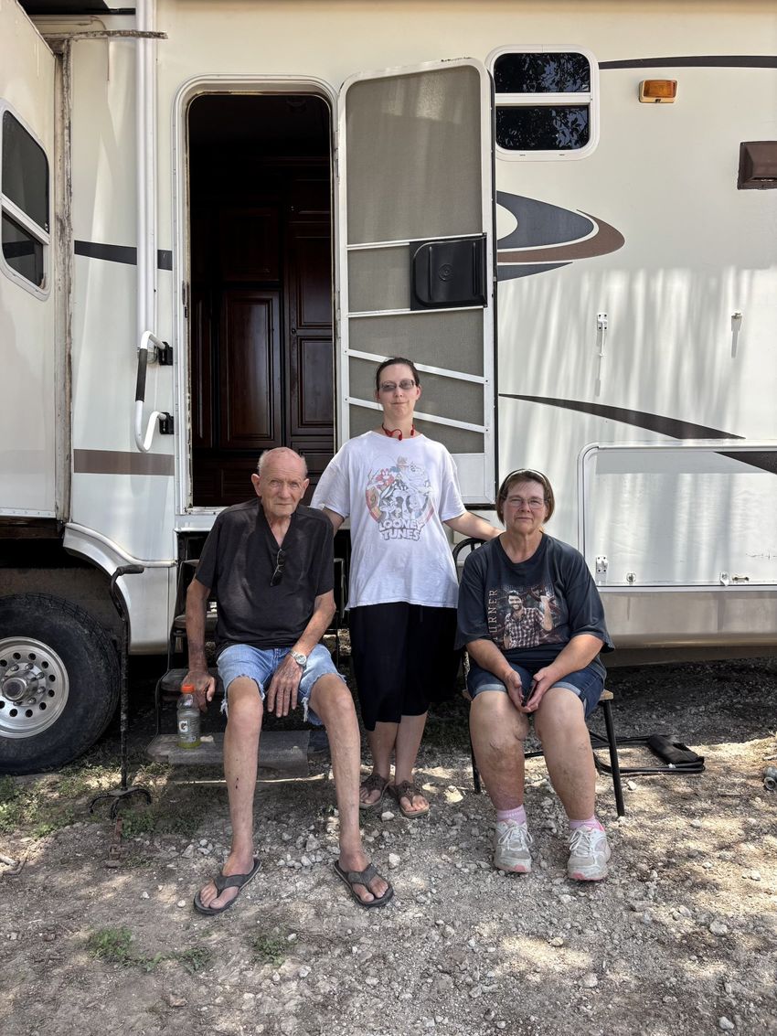 Army veteran Harry Sherwood sits with his step-daughter Tammy Roe and granddaughter Tamera Garcia outside a camper provided by Veterans First at his home in Sandy Creek. He settled there about 35 years ago, and moved to higher ground in 2003 after his mobile home flooded. He figured he was safe, but the flood took almost all he had. “Looking at it now, you’d never be able to tell how beautiful it used to be out here,” Tamera said.