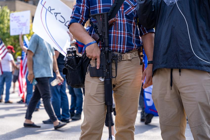 A man carrying an assault rifle participated in the "Stop the Steal" rally at the state Capitol.