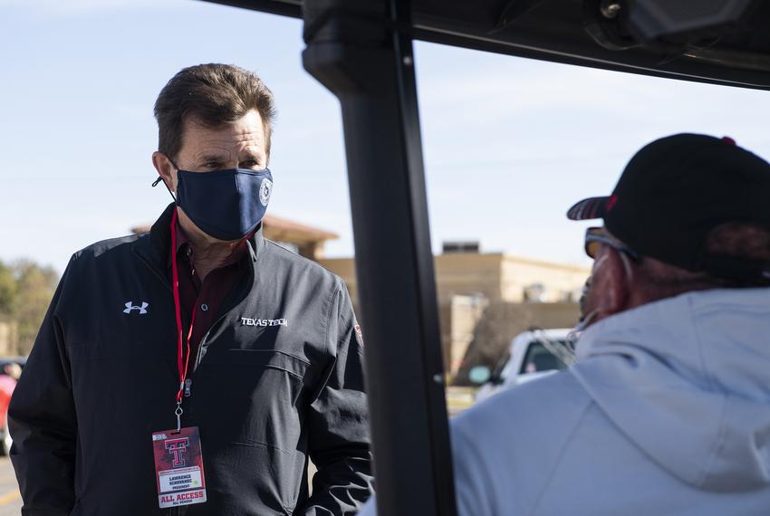 Texas Tech University President Lawrence Schovanec talks to Keith Kiser before Texas Tech's home coming game against West Vi…