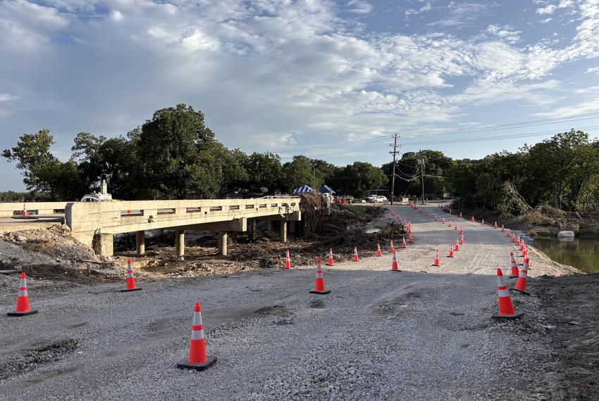 Orange traffic cones divide a low-water crossing on Big Sandy Creek that was completed July 14 after floods damaged the bridge, prompting its closure.