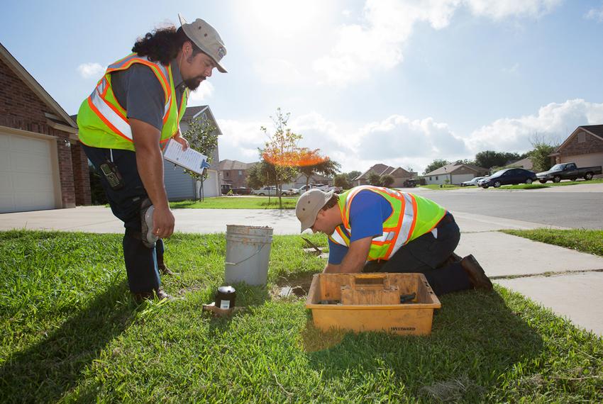 Utility workers in Round Rock install a new electronic water meter intended to save water and lower the costs for consumers.