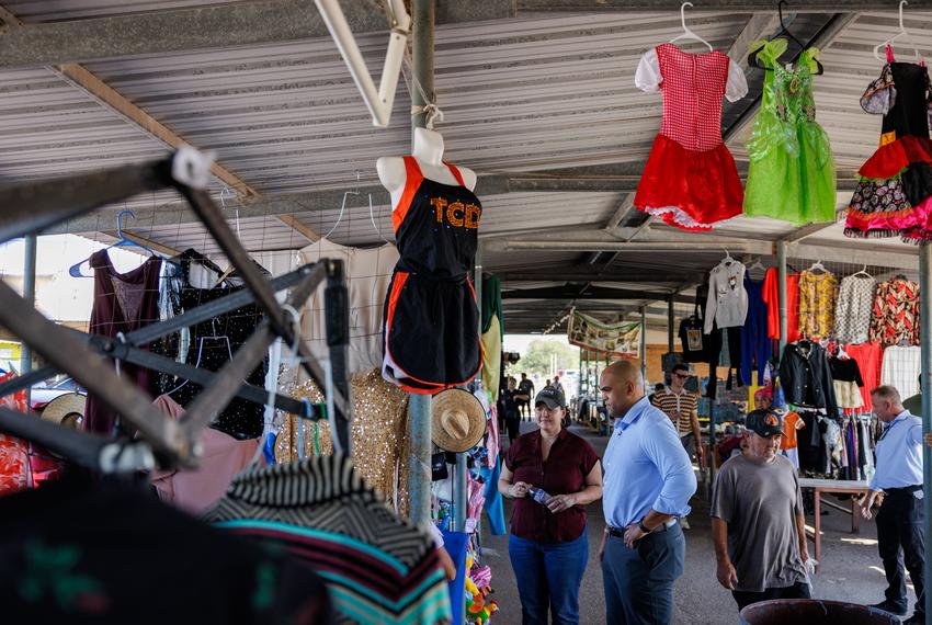 Former U.S. Rep. Colin Allred and former TX-15 Democratic candidate Michelle Vallejo talk to a vendor at Pulga Los Portales in Alton on Oct. 2, 2025.