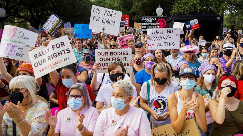 People hold signs and clap during the Womenís March ATX at the Texas Capitol in Austin, Texas, on Saturday, Oct. 2, 2021. Thousands of people attended the rally in support of womenís reproductive health and access to safe abortions.