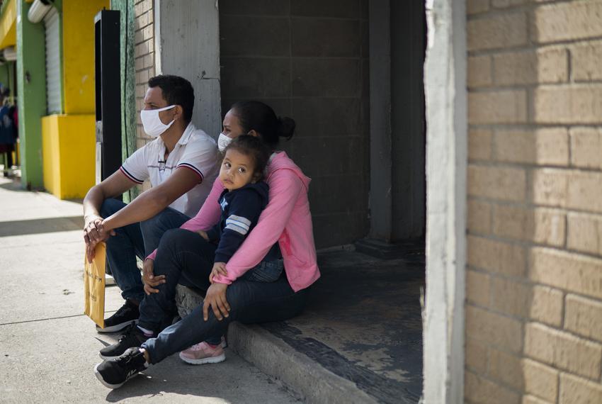 From left: Jose Alfredo Ledezma, 35, and Idxi Martinez, 24, of Honduras, sit with their one year old daughter outside of Catholic Charities Humanitarian Respite Center in McAllen on Aug. 2, 2021.