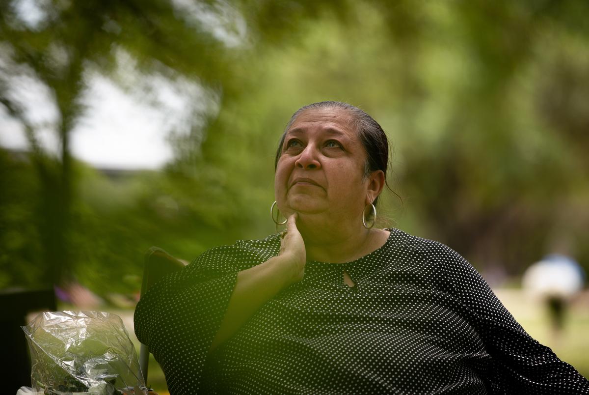 Brenda Ramos visits the grave of her son, Michael Ramos, at Assumption Cemetery in Austin on April 19, 2021.  Ramos was shot and killed by Austin police officer Christopher Taylor last year.