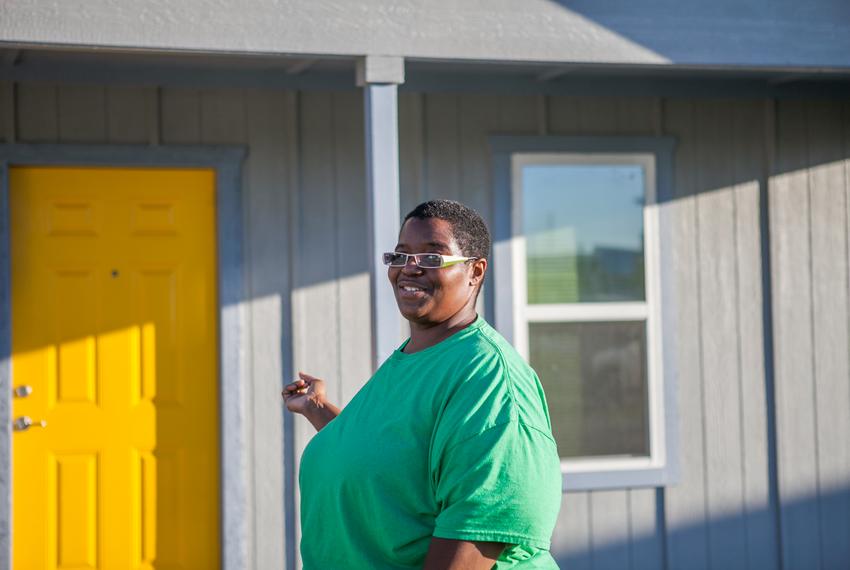 Sharon Jones, 38, outside her new home in east Austin. Before building her house, she received Section 8 housing aid for 10 years.