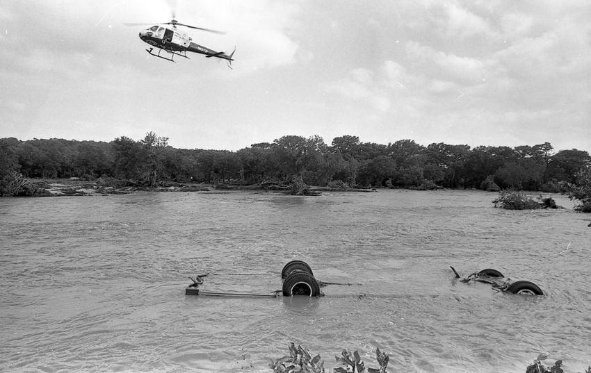 First responders and rescue teams converge on the scene where a church bus from the Dallas area was swept into the Guadalupe River near Comfort on July 17, 1987. Floodwaters claimed the lives of 10 children attending the church camp.