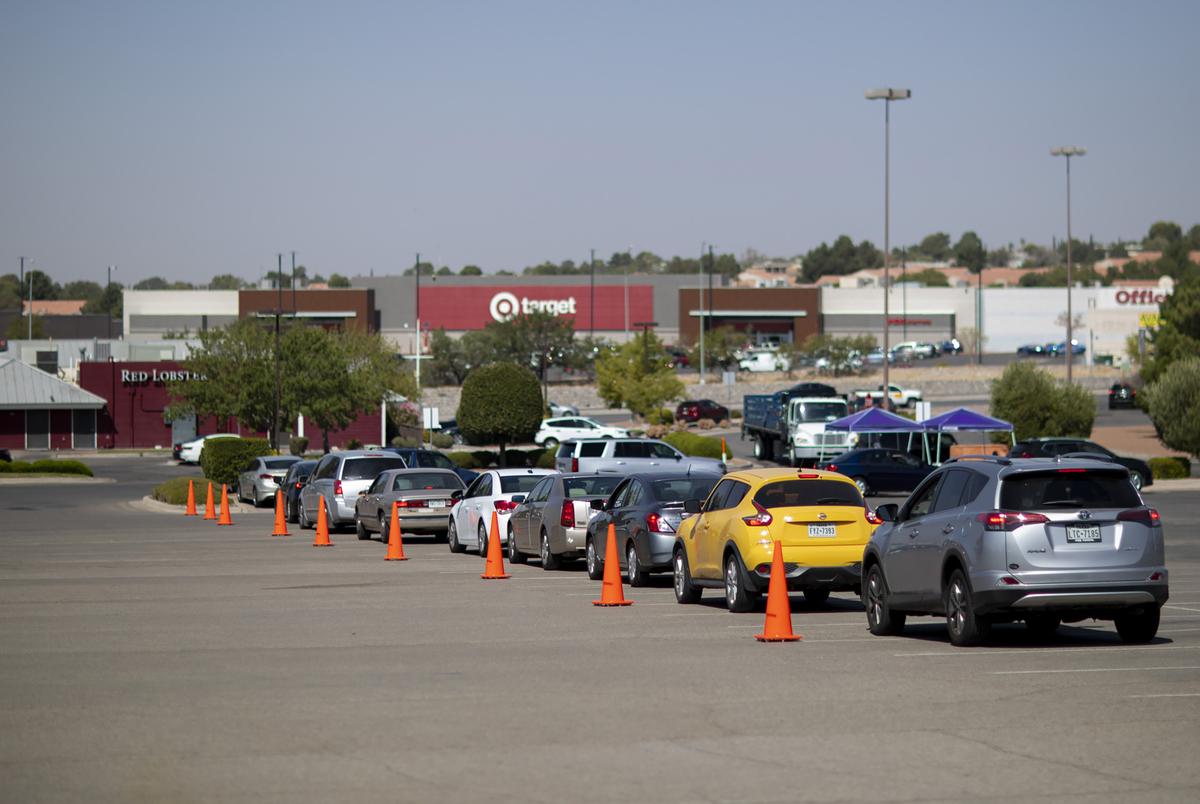 Cars line up on the first day of early voting in El Paso at the Sunland Park Mall drive-thru voting site on Oct. 13, 2020.