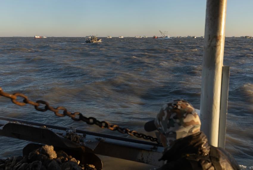 Neighboring oyster boats maneuver around the harvesting zone in Trinity Bay, outside of Texas City, on the first day of the oyster harvesting season, on Nov. 1, 2023.