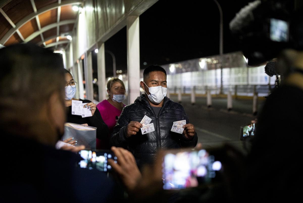 A man shows his Mexico-issued vaccination card as he waits at the top of the Paso del Norte International Bridge to cross into the U.S. as a nonessential traveler at 12:01 a.m. EST, on Sunday Nov. 7, 2021, in Ciudad Juárez, Mexico. The man and his family are some of the first persons to cross into El Paso from Ciudad Juárez after the reopening of the border to vaccinated nonessential travelers. The border had been closed for nearly 20 months due to the global pandemic.