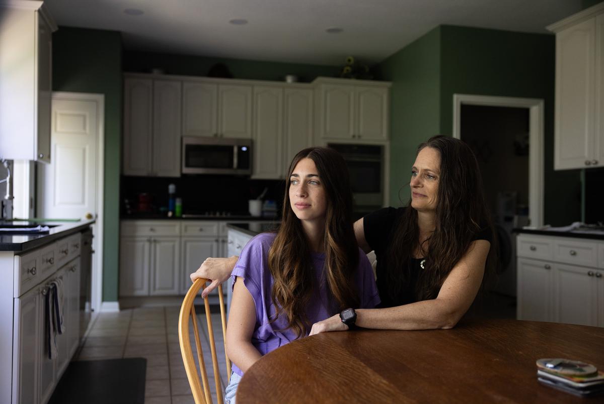 Tiffanie O'Brien, right)=, looks toward her daughter, Abbey, as they sit in their neighbor’s home near Lake Austin on Aug. 8, 2025. Both women testified in favor of banning reunification therapy, a form of court ordered family therapy that Abbey started going into her final year of high school in 2024. Abbey and her mom were separated for several months without a way to communicate with one another so that Abbey could spend time with her dad.