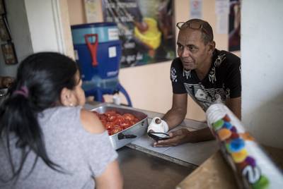 Reinaldo Ramirez Pacheco of Cuba talks to his wife in the rectory at El Buen Pastor migrant shelter in Ciudad Juárez on May 13, 2019. They have been at the shelter for two months.