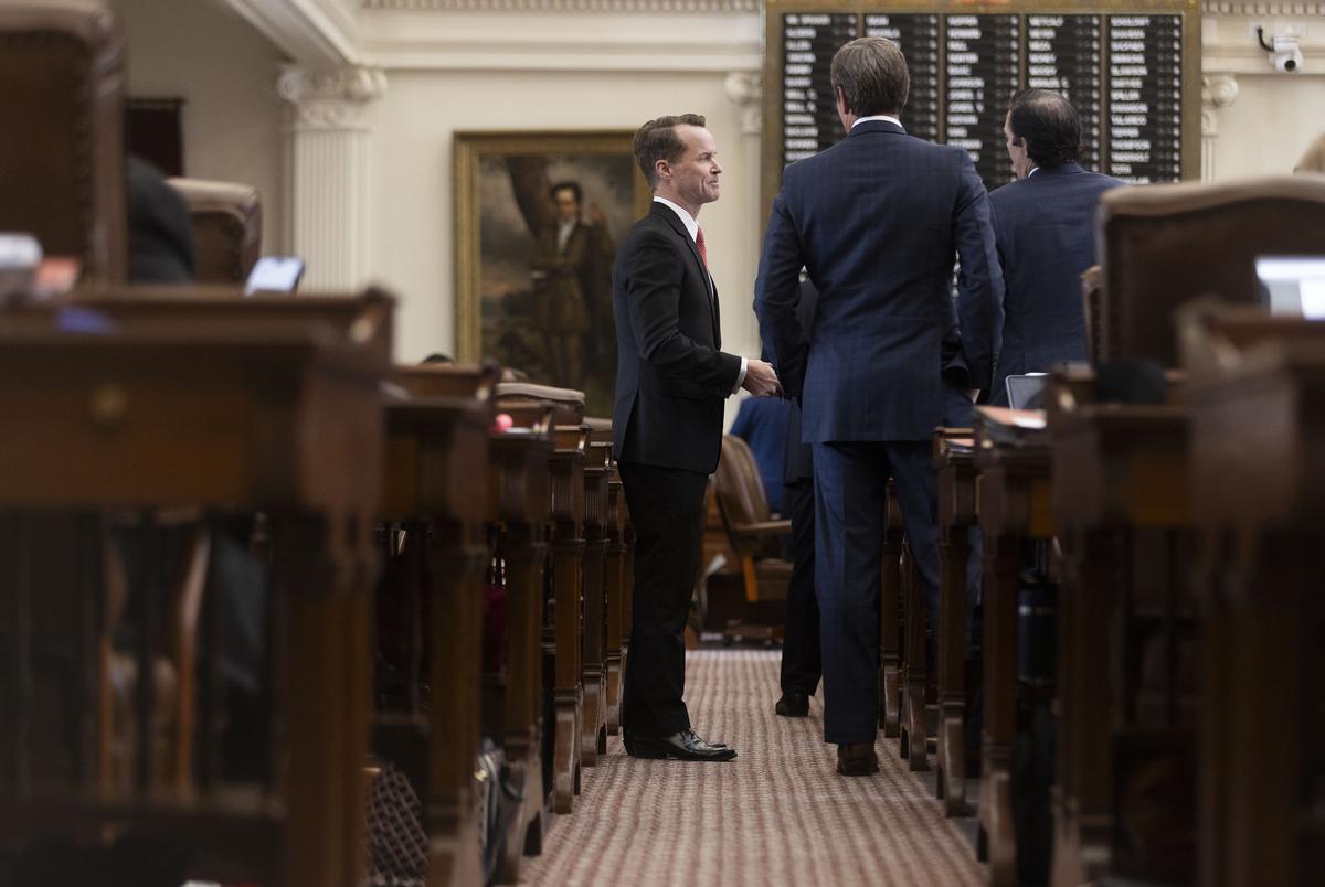 State Rep. Dade Phelan, R-Beaumont, speaks with other representatives on the House floor on May 19, 2025.