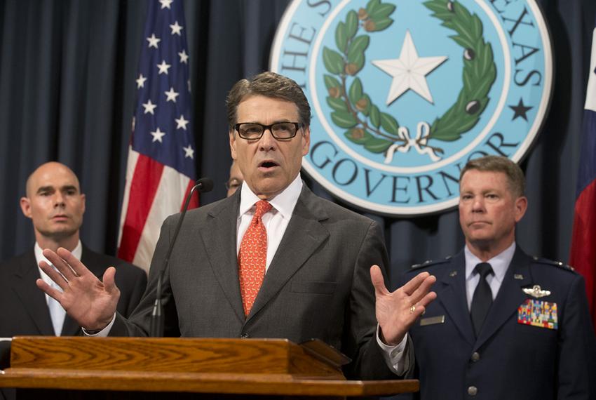 Gov. Rick Perry, flanked by State Rep. Dennis Bonnen, R-Angleton, and Texas Adjutant General John Nichols, announces the deployment of National Guard troops to the Texas border on July 21, 2014.