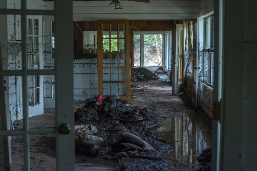 Mud and debris fill the home of James Wright on Wednesday, July 9, 2025, in Hunt, Texas.