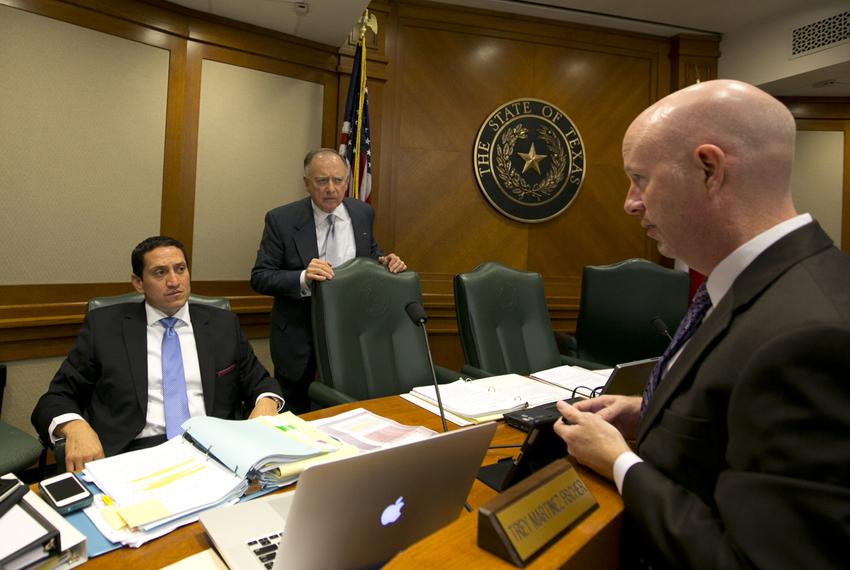 Rep. Trey Martinez Fischer, D-San Antonio, and Rep. Dan Flynn, R-Canton, speak with a lawyer during a break at a House Committee on Transparency in State Agency Operations hearing on October 23rd, 2013