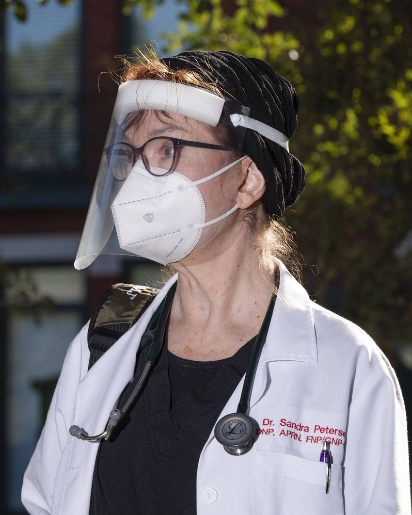 Medical doctor Sandra Petersen wearing some of her personal protective equipment before seeing COVID-19 patients inside The …