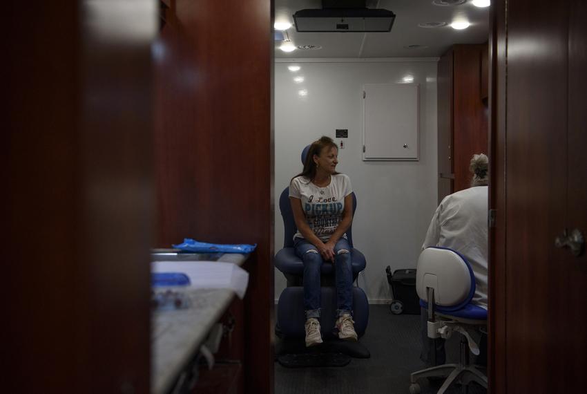 Shelly Huffman meets with a nurse practitioner as patients receive healthcare at a mobile health clinic in Kirbyville, Texas, U.S., on Monday, October 17, 2022.